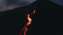 Lava flows from Volcanic eruption at Pacaya Volcano in Guatemala at night. Drone aerial	