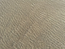 shallow water ripples over sand