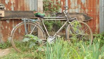 old bike leaning against a shed in Kenya 