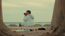 Man taking pictures at the beach
