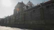 Pov tilt up of famous Puebla Cathedral with grid and bright sunny day in background, Mexico	