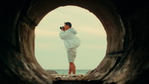 Man taking pictures at the beach
