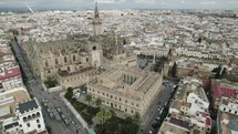 Stunning Seville Cathedral with distinctive Gothic architecture; aerial pan