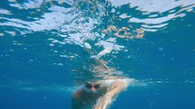 Boy Swimming In The Ocean