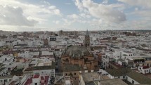 Santa Ana church at Seville and cityscape, Spain. Aerial circling