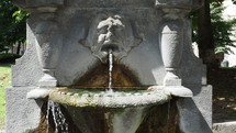 zooming out on an ancient stone fountain