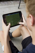 child playing soccer on a tablet 