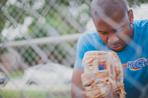 man in prayer in a baseball diamond