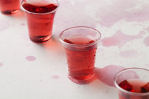 spilled red wine in communion cups 