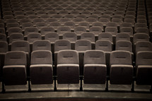 Rows of empty seats in an auditorium.