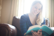A woman reading a Bible at a Bible study 
