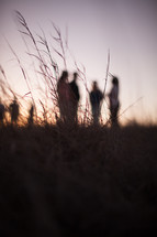 group of people standing in a field 