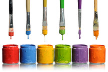 rainbow of colored paints and paint brushes 