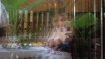 Woman with baby in glass reflection