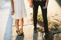 a couple standing on a sidewalk 