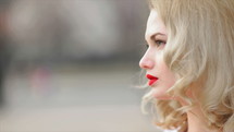 face of a young woman with red lipstick 