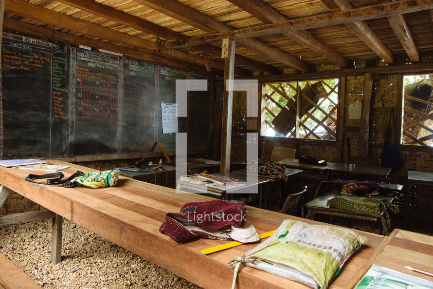 bags on desks in a classroom in Matiu Village 
