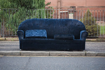 discarded couch on the side of the road 