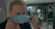 Young blond woman wearing surgical mask