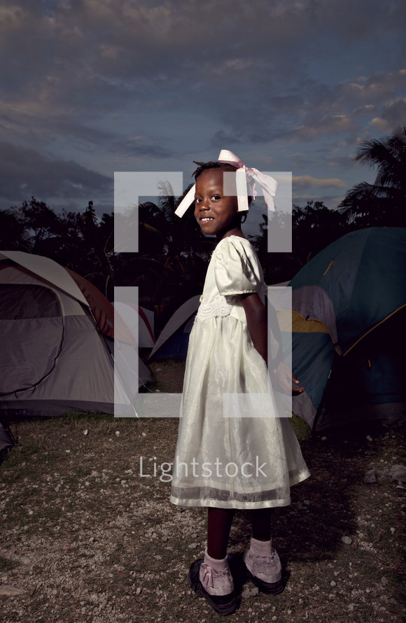 Young girl standing in camp ground