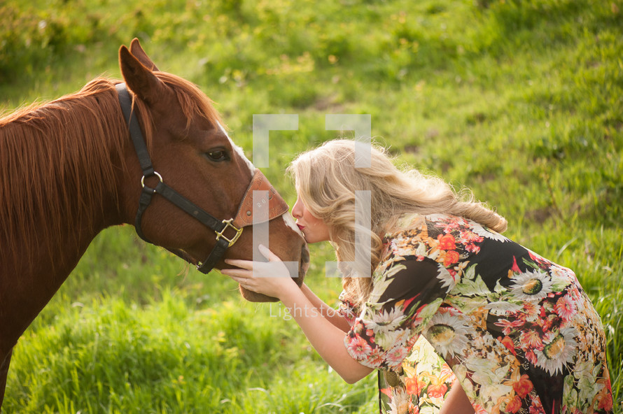 a woman kissing a horse 
