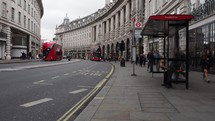LONDON, UK - CIRCA SEPTEMBER 2019: People walking on the pavement and double decker bus travelling in Regent Street