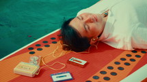 Asian man lying on the boat and relaxing
