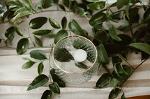 floating votive candle and greenery 