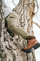 a woman climbing a tree