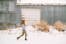 a woman walking in snow 