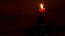 a candle stick with a wood background