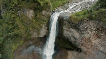 Aerial drone shot of Water Cascading Down The Cliff, Manto de la Novia Waterfall In Baños, Ecuador.