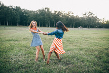 friends holding hands in a field of green grass 