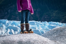 a girl standing on a glacier
