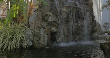 Decorative rocky waterfall in the garden