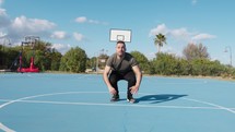 Man Does Push Ups Burpees With Jump In Blue Basketball Court Outdoors