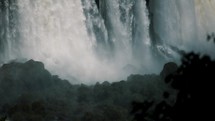 Powerful Water Stream Falls Down The Cliffs, Iguazu Waterfalls In Argentina And Brazil Border. Tilt-up Shot