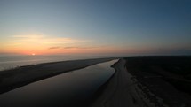 Aerial descending drone shot over the sunset on Langeoog Island, Germany.