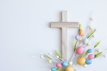 Cross with colourful easter egg decorations on white