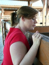 a woman looking into a stable 