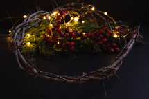 Christmas garland with red berries and twinkle lights
