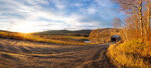 Path leading to covered footbridge during autumn panorama