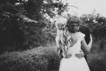 bride and groom hugging 