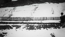 Old narrow gauge steam train in the countryside filmed in B/W.
