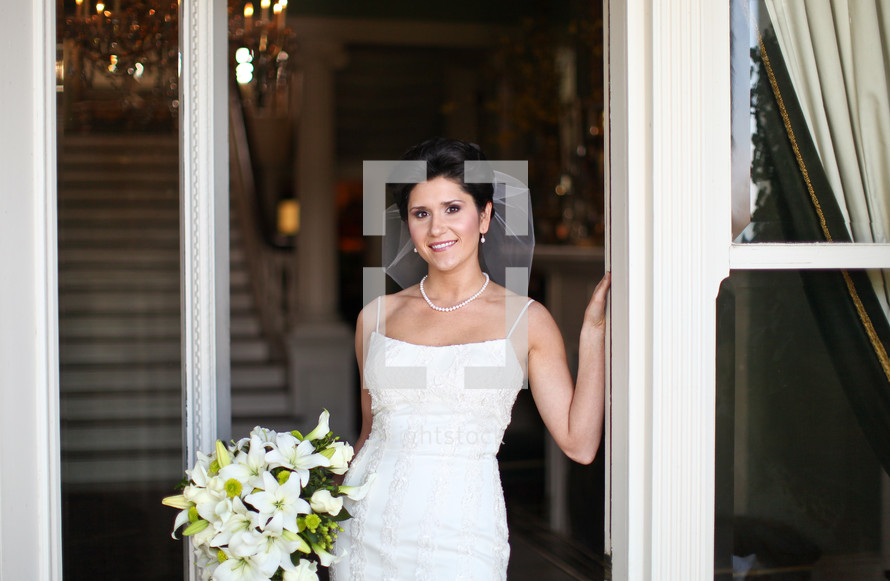 bride standing in a doorway outdoors