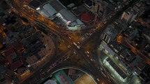 Rush Hour Traffic At The Intersection In Quito City, Ecuador During Nighttime. aerial drone top-down	