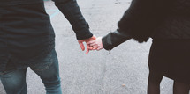 couple walking holding hands 