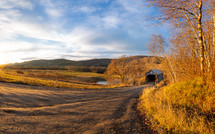 Path leading to covered footbridge during autumn panorama