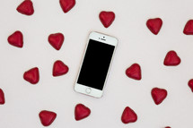 red heart shaped chocolates and cellphone 