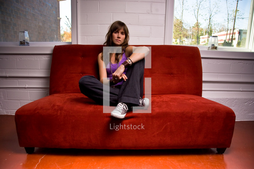 college girl sitting on a red couch